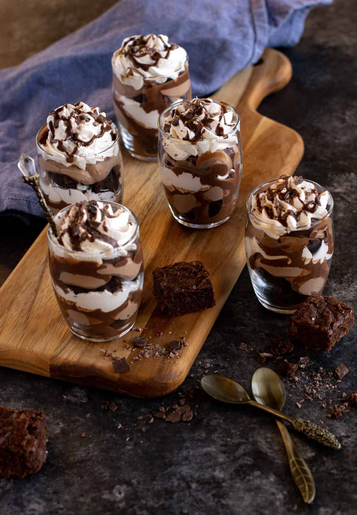 Brownie mousse trifle with brownie pieces on the side. 